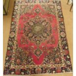 A red ground vintage Tabriz rug with floral medallion design, 282cm x 186cm Condition Report: