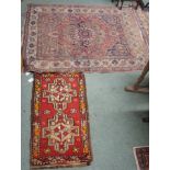 An Eastern ground, 140cm x 113cm and a red ground Yastik mat, 90cm x 40cm (2) Condition Report: