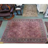 A pink ground wool rug will allover design, 125cm x 180cm and a green ground rug 89cm x 142cm (2)