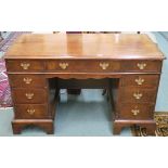 A Georgian style mahogany kneehole desk with bracket feet, 72cm high x 122cm wide x 60cm deep