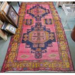 A Vintage pink ground washed Northern Iranian rug with medallion design, 309cm x 154cm Condition