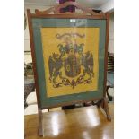 A mahogany firescreen with heraldic panel Condition Report: Available upon request
