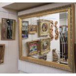 A modern gilt wall mirror and a small brass wall mirror (2) Condition Report: Available upon