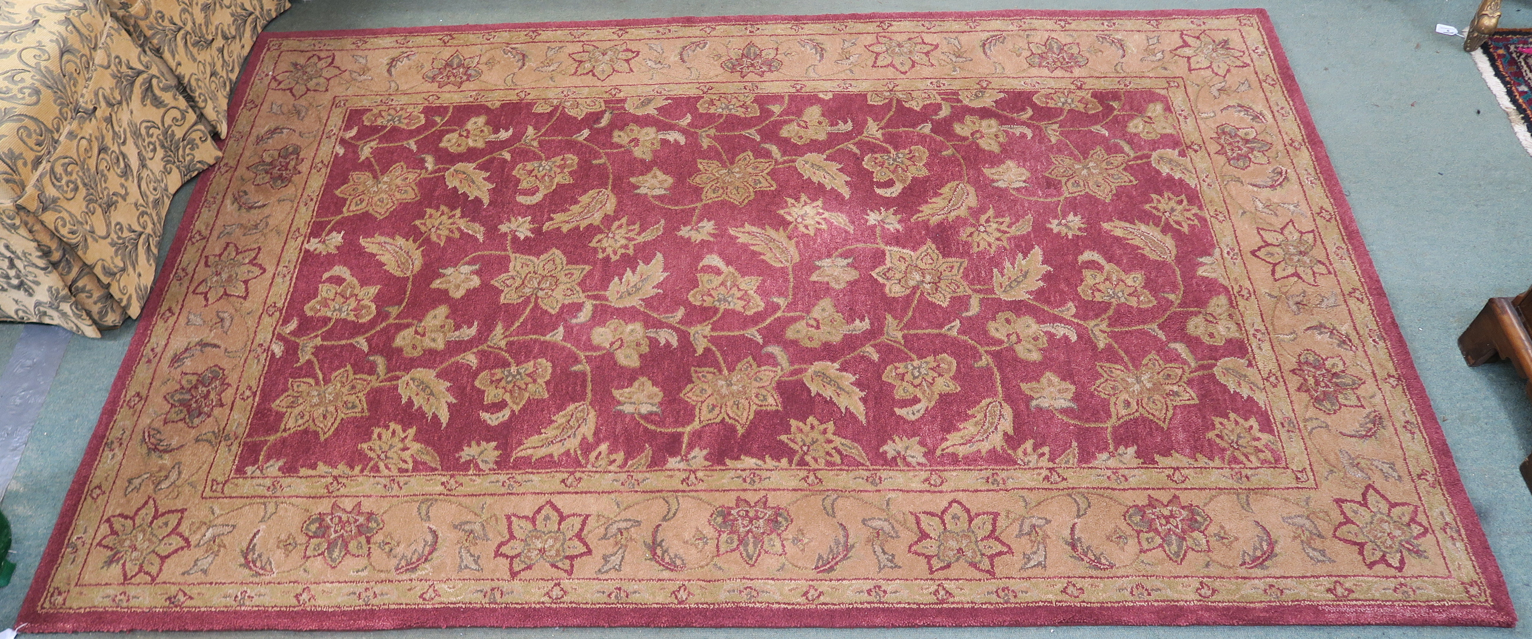 A Burgundy ground wool rug with dark beige floral pattern, 254cm x 160cm Condition Report: Available