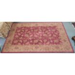 A Burgundy ground wool rug with dark beige floral pattern, 254cm x 160cm Condition Report: Available