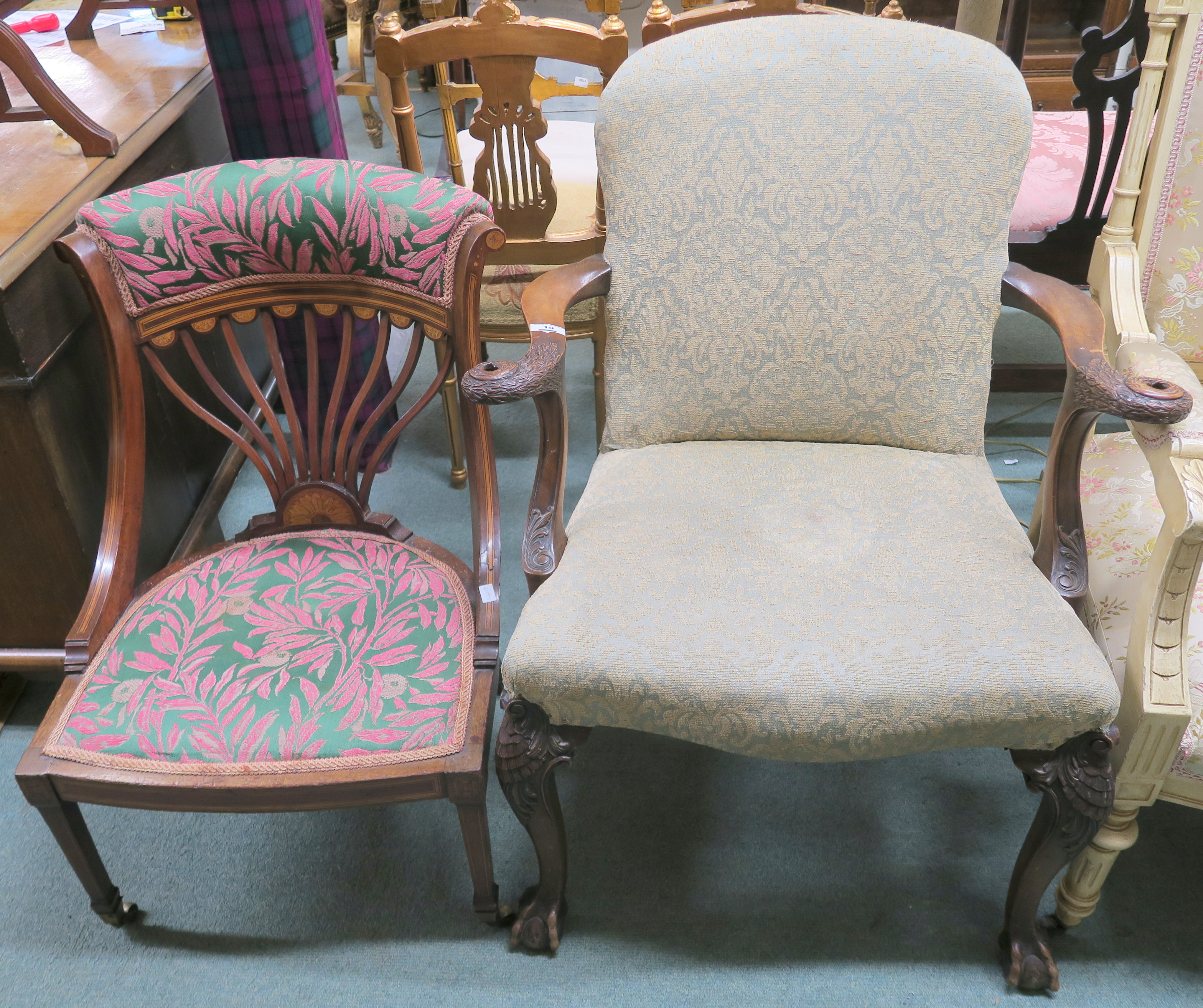 A walnut armchair with carved eagle arms with carved legs on ball and claw feet and an Edwardian