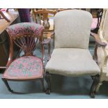 A walnut armchair with carved eagle arms with carved legs on ball and claw feet and an Edwardian