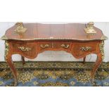 A Louis XV style writing desk with central drawer flanked by a pair of drawers with gilt metal