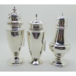 A lot comprising three silver sugar castors, Birmingham 1916, 1921 and 1955, the tallest 18cm