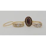 A 9ct gold garnet cluster ring size L1/2, a 9ct cz cluster ring size N1/2, a 9ct three cz three
