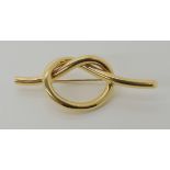 An 18ct gold lover's knot brooch, length 6.4cm, weight 10.2gms Condition Report: Available upon