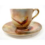 A Royal Worcester demitasse cup and saucer painted with a oriental pheasant, unsigned Condition