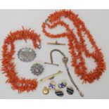 Two strings of coral fringe beads, a silver Albertina, silver anchor brooch and other items