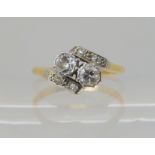 A yellow metal twin stone diamond ring, set with estimated approx 0.20cts of old cut diamonds,