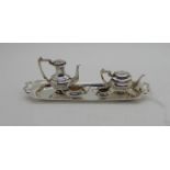A miniature four piece silver tea and coffee set on tray, the tray 15cm across the handles,