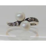 A yellow metal twin pearl and diamond ring, each pearl approx 6mm, finger size P, weight 3.9gms