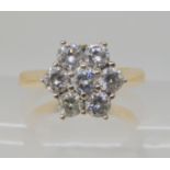 An 18ct gold diamond flower ring set with estimated approx 1ct of brilliant cut diamonds, finger