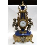 An Italian mantle clock flanked by fauns, with German movement marked FHS 130-070, 61cm high