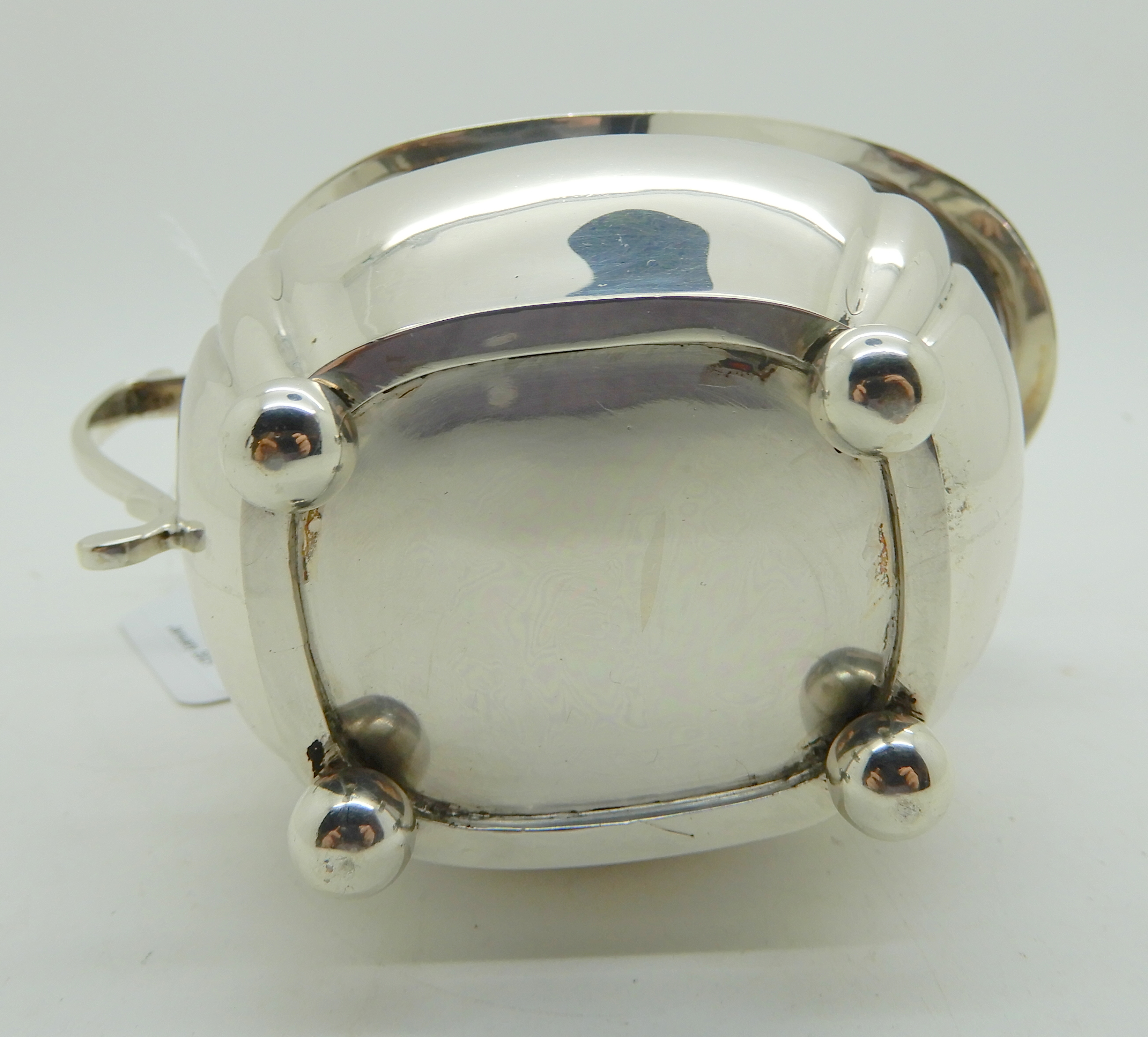 A silver cream jug, London 1924, of rounded rectangular form with lobed corners on four ball feet, - Image 5 of 5