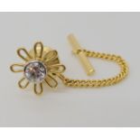 A bright yellow metal flower shaped tie stud set with a 0.40ct diamond, weight without gold plated