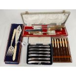 A lot comprising two cased knife sets, a cased carving set and a cased pair of fish servers (4)