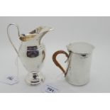 A lot comprising a silver lidded jug, Birmingham 1903, 9cm high and a silver helmet shaped cream