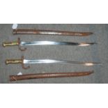 Two French bayonets with inscribed blades and metal scabbards, 71cm overall (2) Condition Report: