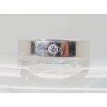 A De Beers Radiance 18ct white gold diamond band ring, set with a 0.12ct brilliant cut diamond,