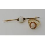 A yellow metal Art Deco style bar brooch set with an opalite gem, length 6.4cm, together with a