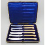 A cased set of six silver and bone pistol grip butter knives, London 1910 Condition Report: