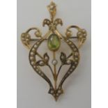 A 9ct peridot and pearl Edwardian pendant brooch, dimensions 4.9cm x 3cm, weight 4.3gms Condition