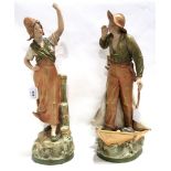 A pair of Royal Dux figures, no's 1817 and 1818, he boy modelled standing on a boat bow, 49cm high