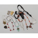 A rock crystal pendant, a pair of Butler & Wilson dog earrings, a coral necklace and other items