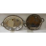 A lot comprising a circular EP double handled serving tray and an oval tray, the oval tray 56.5cm