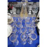 A suite of eight cut and gilded wine glasses and six smaller glasses, together with a jug with