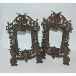 A pair of bronzed picture frames decorated with putti, 36cm high and another, 34cm high (3)