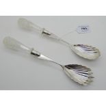 A pair of silver and glass handled salad servers with shell shaped bowls, Birmingham 1889, 26gm long