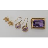 A 9ct gold amethyst brooch, a pair of amethyst earrings and a pair of yellow metal flower