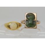 An 18ct gold opal ring size H1/2, together with a 9ct gold New Zealand jade Tiki ring size R1/2
