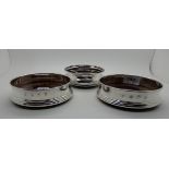 A pair of silver wine coasters, Birmingham 1993, 12cm diameter, with a single silver coaster,