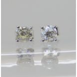 A pair of 18ct white gold diamond stud earrings, set with 0.60cts of old cut diamonds combined,