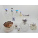 A lot comprising ten assorted silver topped and silver and enamel topped dressing table jars,