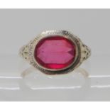 A 14k white gold American ring (possibly made by Birks) set with a red paste stone, size N1/2,