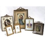 A collection of gilt metal photograph frames with swag and wreath tops, largest 30cm high
