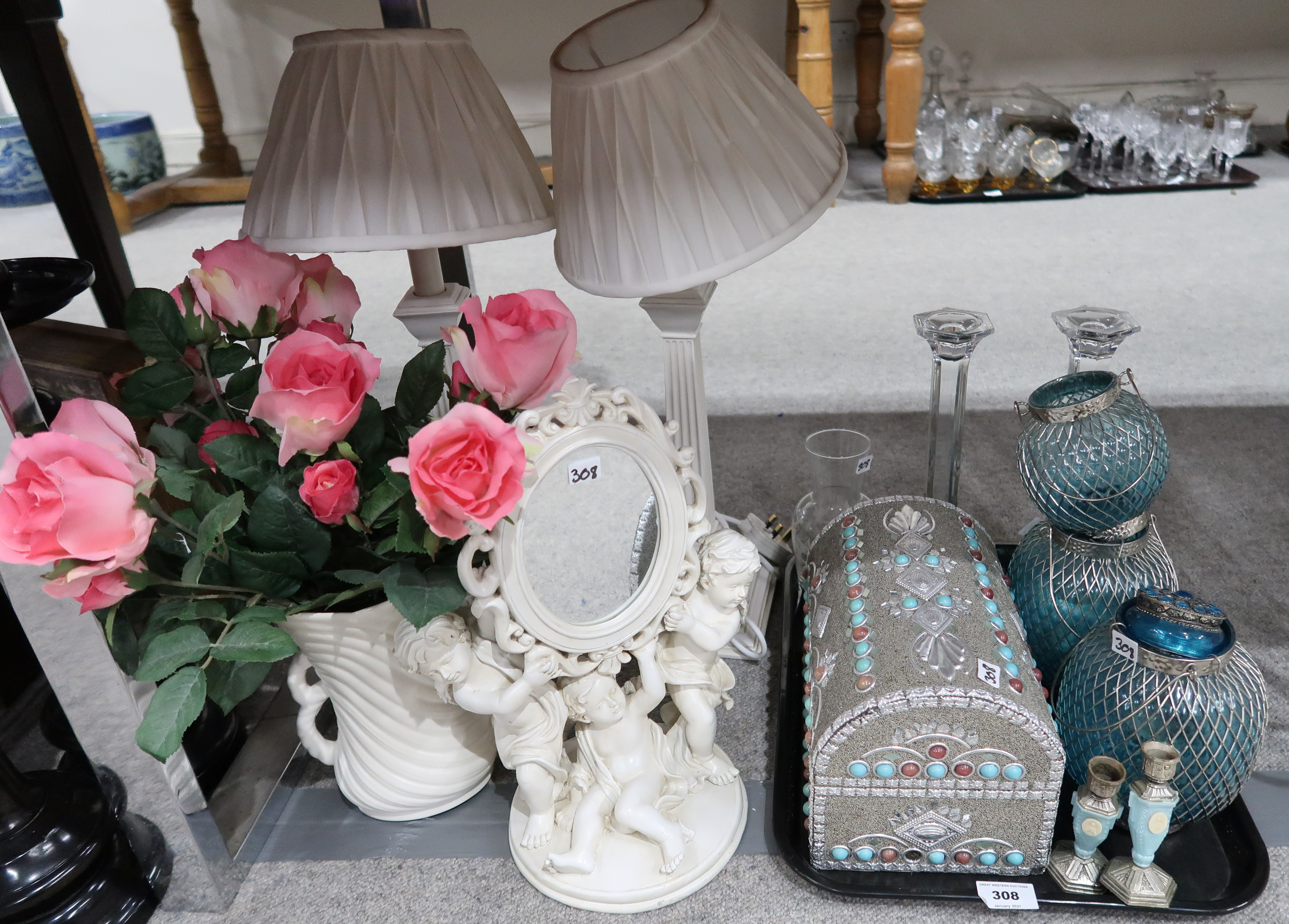 A pair of cream table lamps, a jewellery chest, a cherub mirror, blue glass candleholders etc