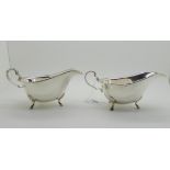 A pair of silver sauceboats, Sheffield 1939, with scrolling handles and on three hoof feet, 15cm