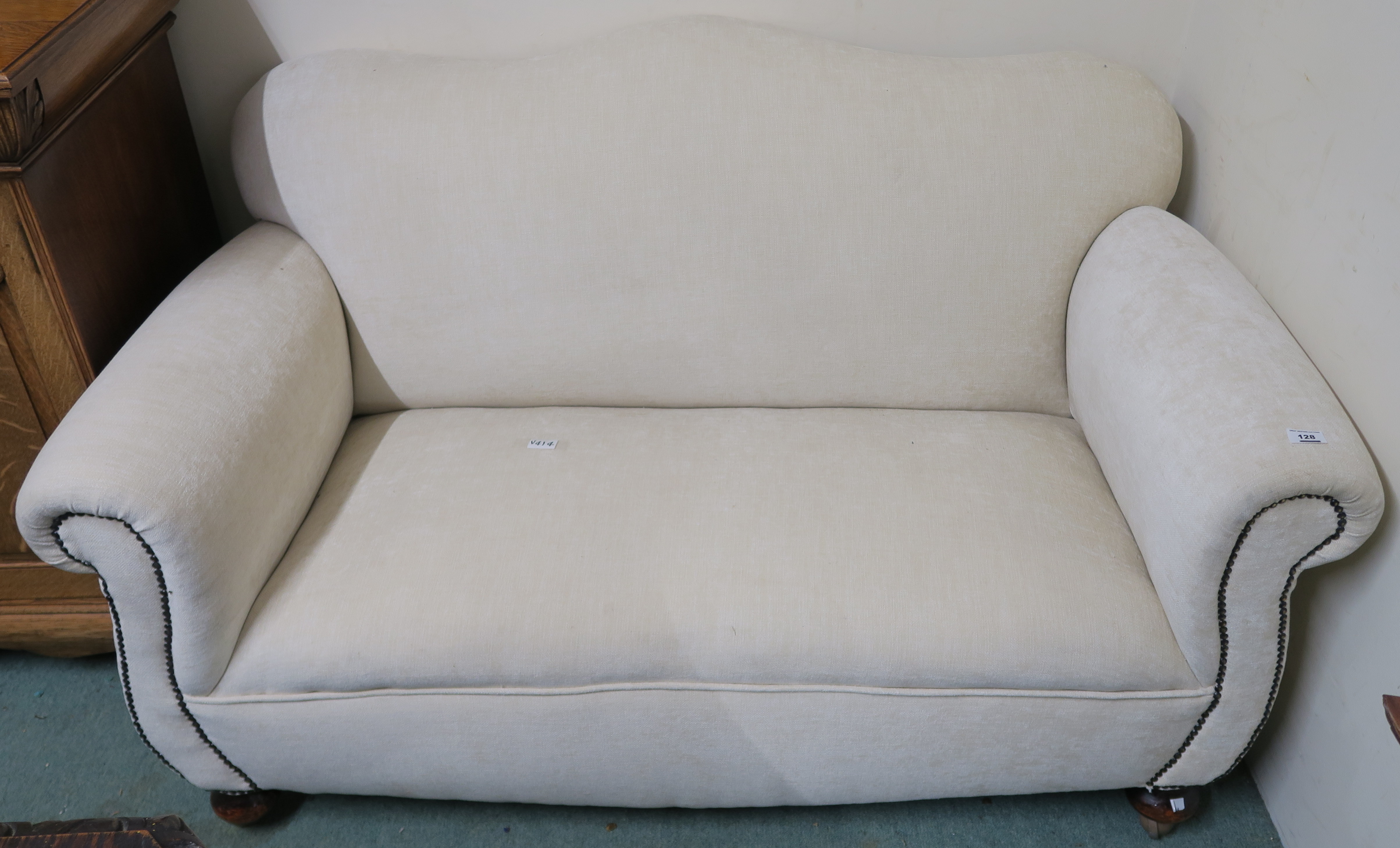 A cream upholstered two seater sofa, 85cm high x 150cm wide x 85cm deep Condition Report:
