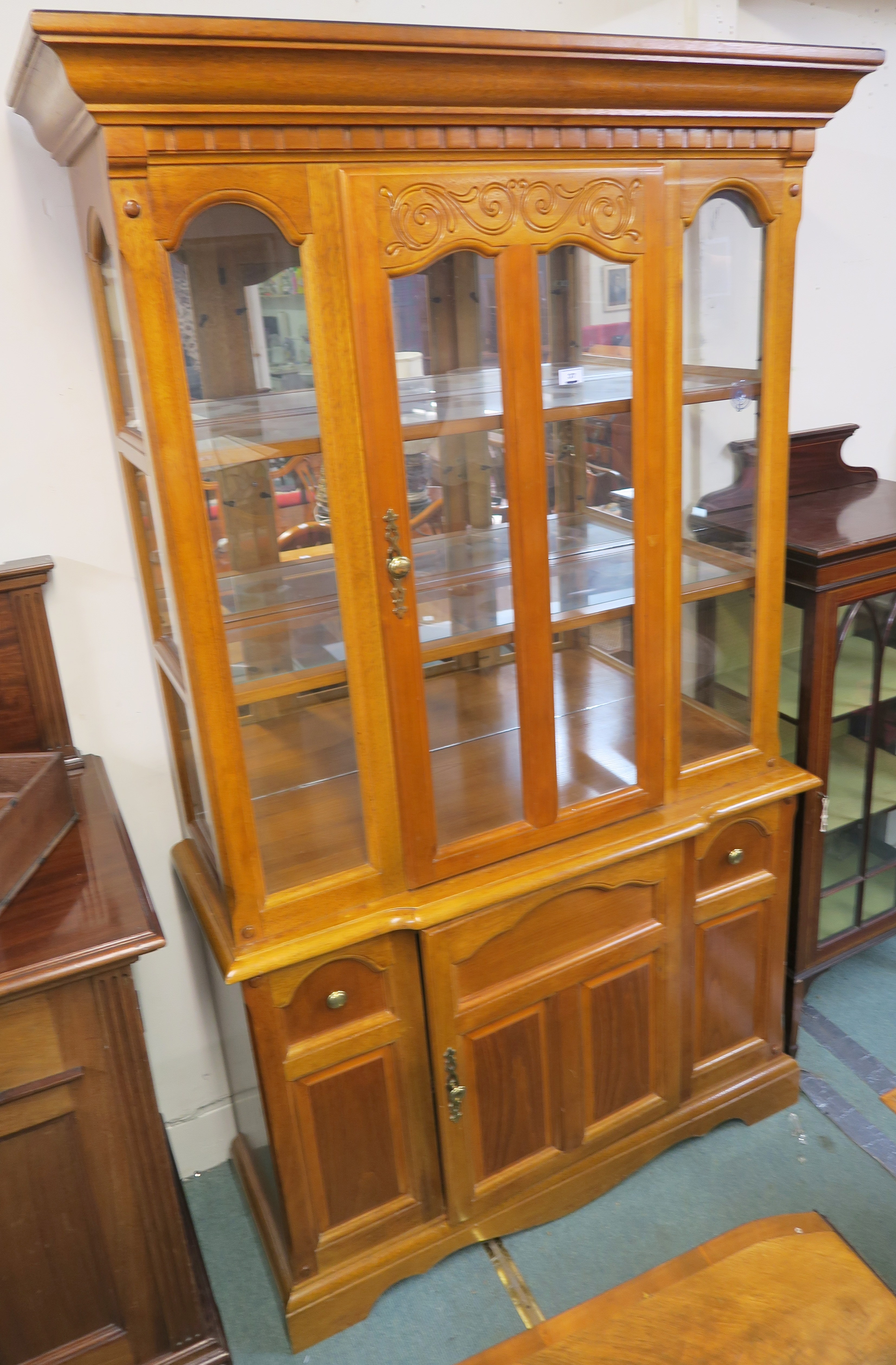 A modern display cabinet with single glazed door over a base with single door, 197cm high x 116cm