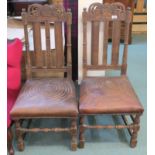 *A pair of carved chairs with leather seats (2) Condition Report: Available upon request