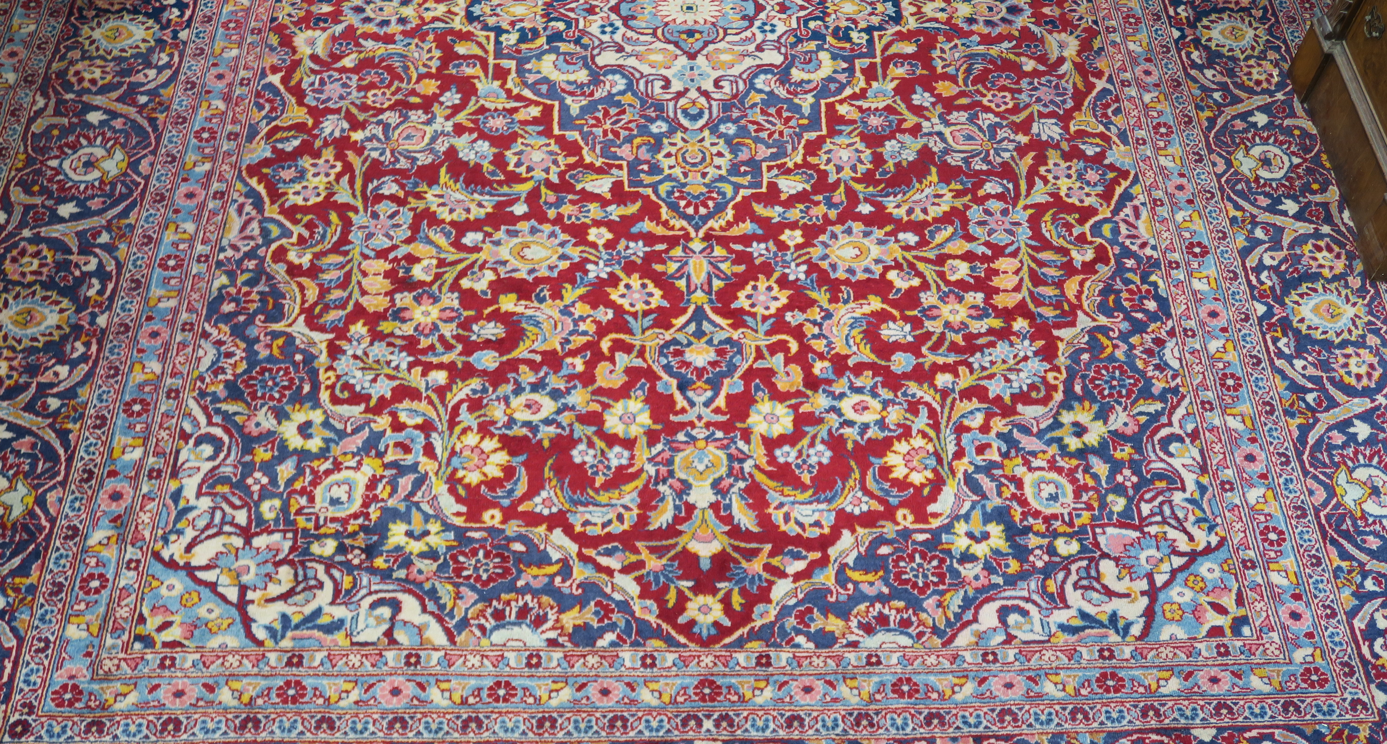 A large red ground Keshan rug with traditional design of blue central medallion, matching - Image 3 of 5